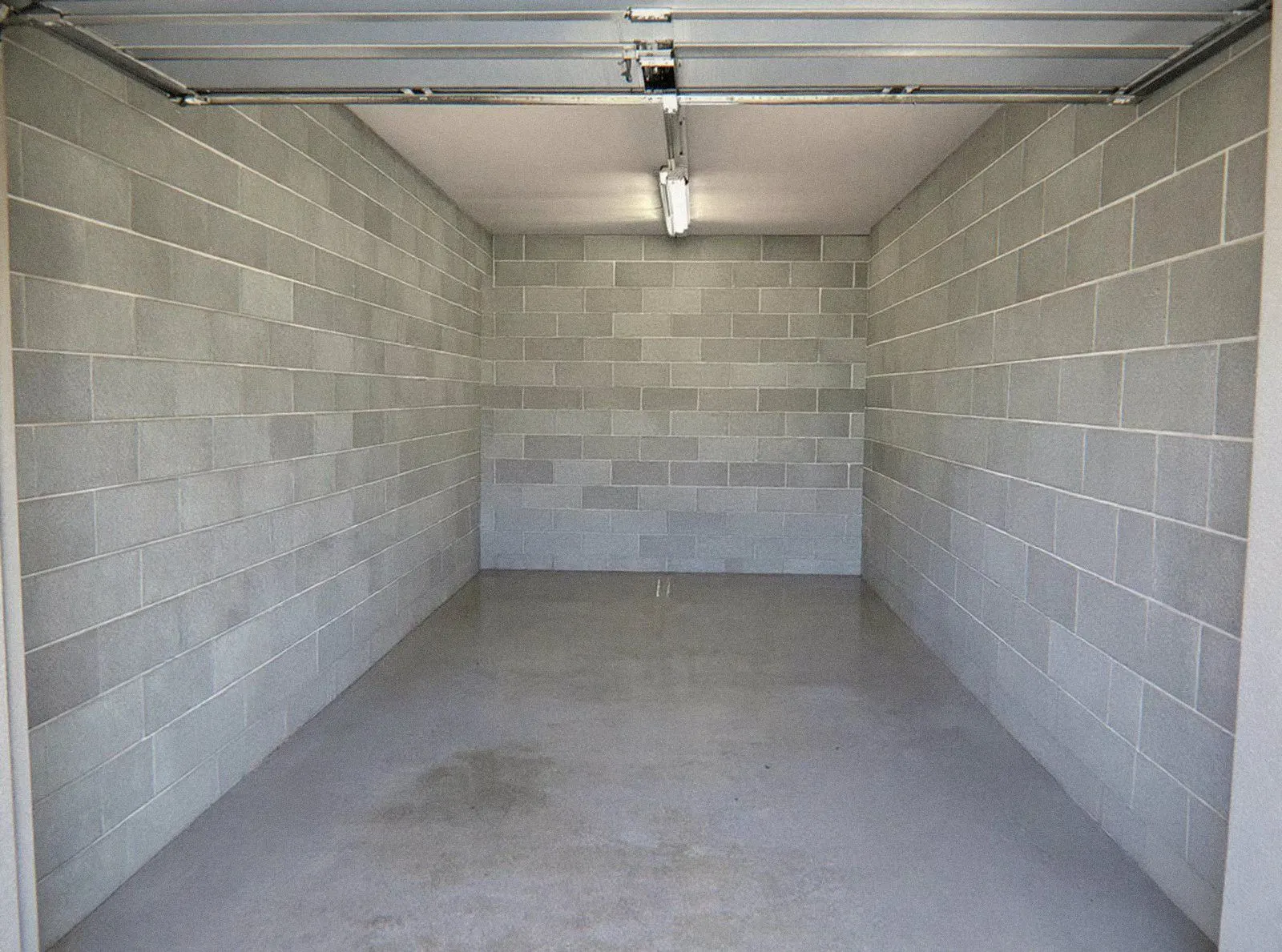 Garage en parpaings entièrement vidé et balayé, photographié après l'intervention d'OPM Débarras